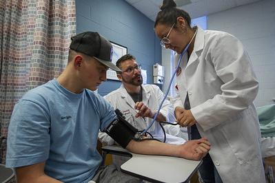 Nursing faculty assisting a nurse educator student